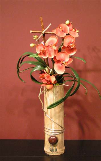 Phalenopsis Orange orchids in bamboo