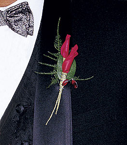 Boutonnière made with rolled rose petals and foliage