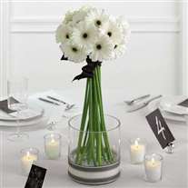 Wedding flower arrangement with white gerbera in glass vase