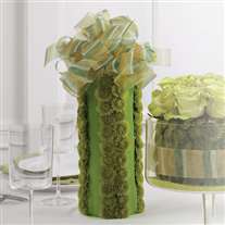 Wedding flower centerpiece. Green tones. Vase covered with fabric and flowers